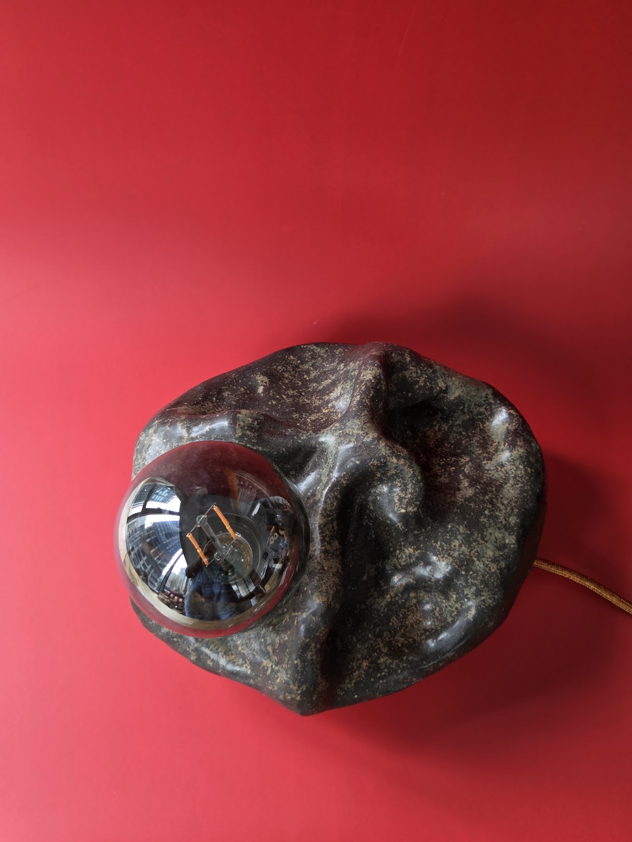 Detail of Shoal's mottled dark glaze folding across its ceramic form
