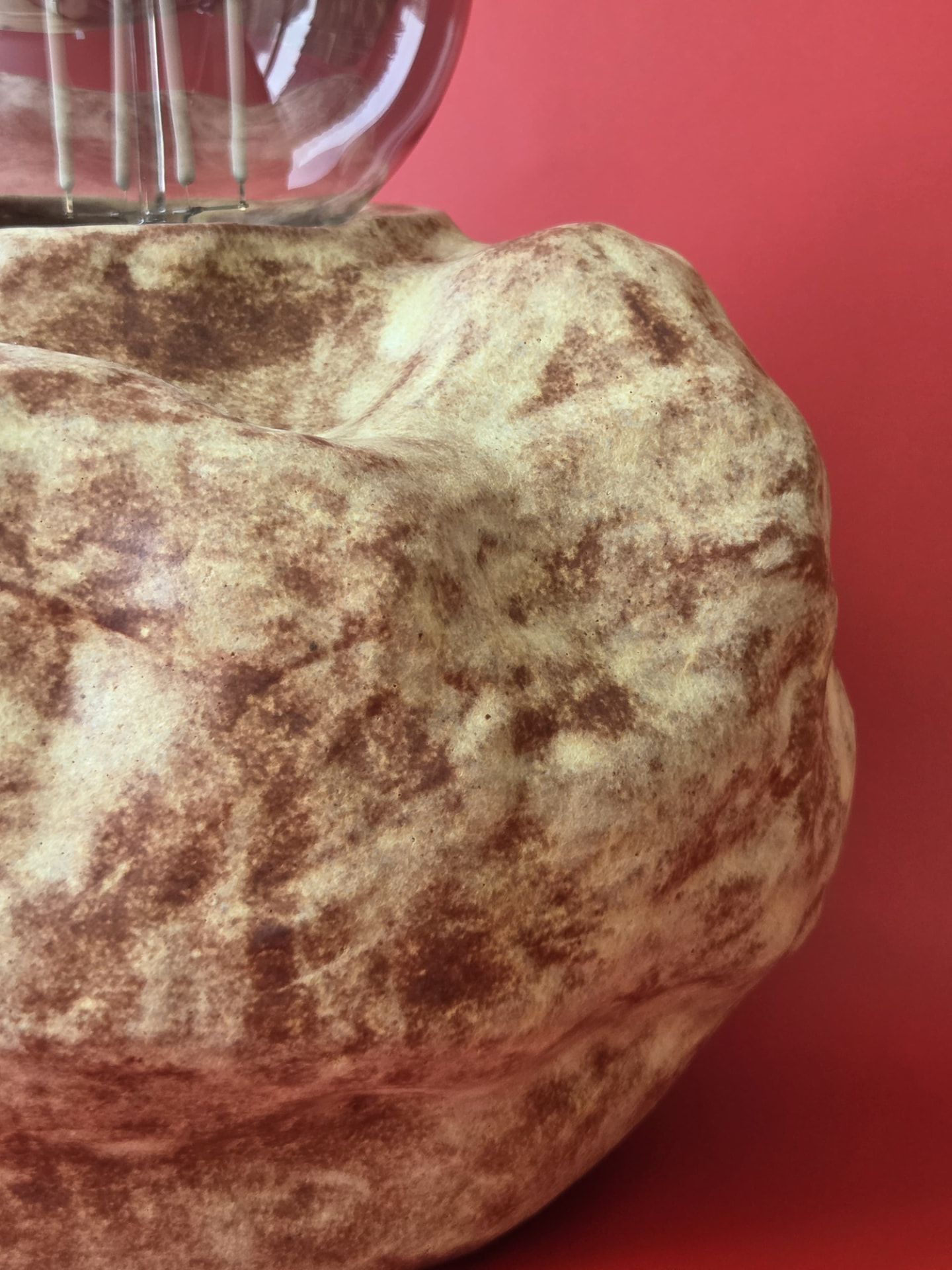 Detail of Erratic's mottled cream and brown glaze across its stone-like form