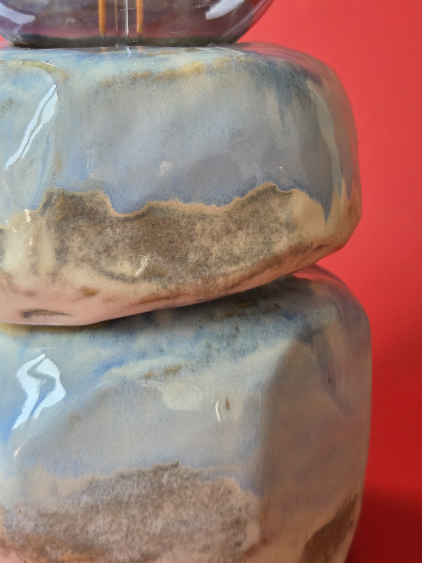 Close detail of Cairn's stacked forms with pale blue and sand-coloured glaze